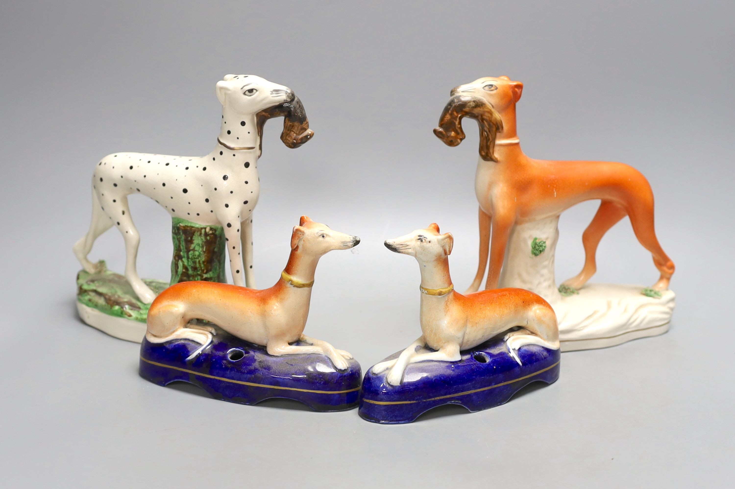 Two Staffordshire greyhounds and a pair of recumbent Staffordshire ‘greyhound’ desk stands. Largest 19cm